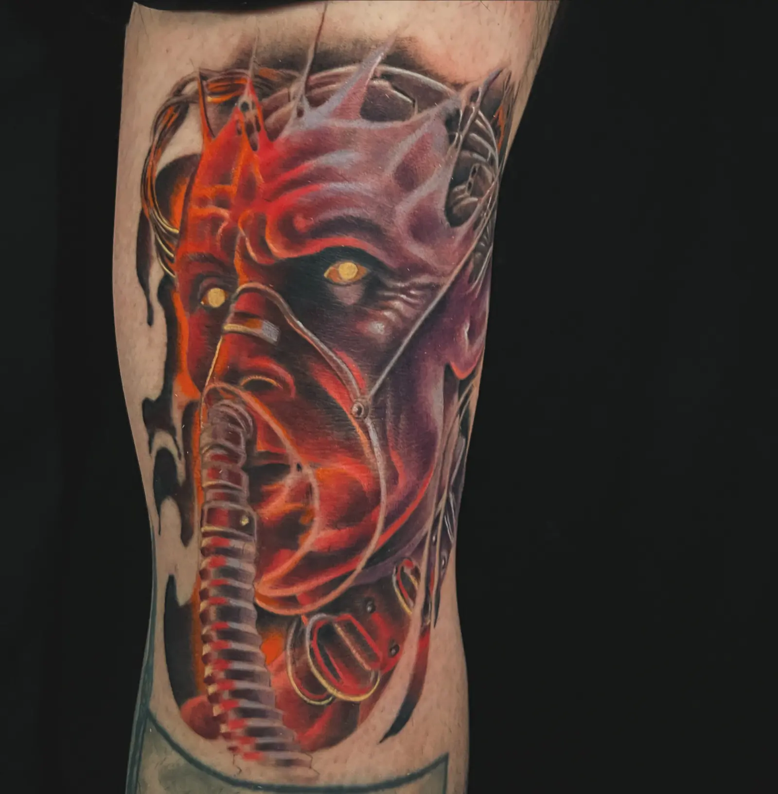 Full-color biomechanical face forearm tattoo by Keith