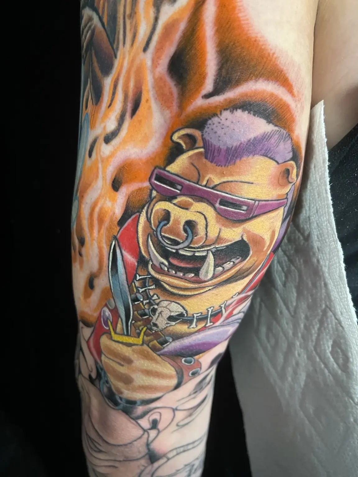 Full-color character tattoo with flame background by Keith