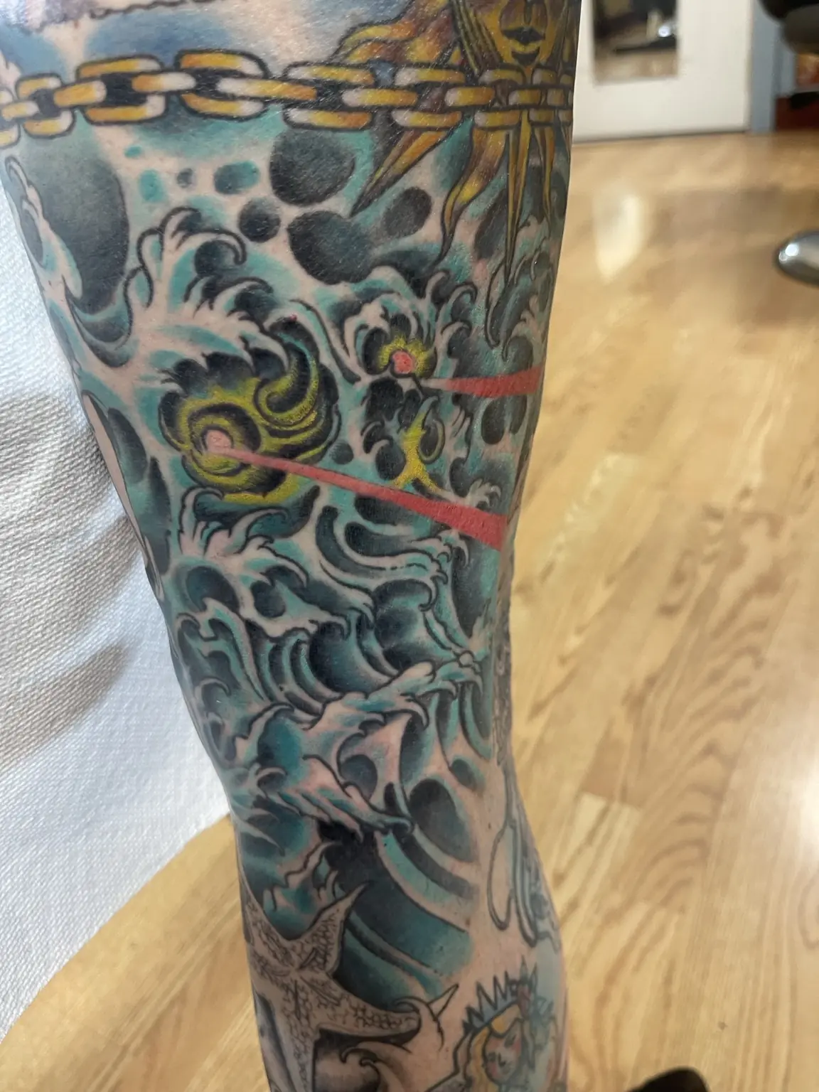 Full-color Japanese-inspired waves sleeve tattoo by Keith