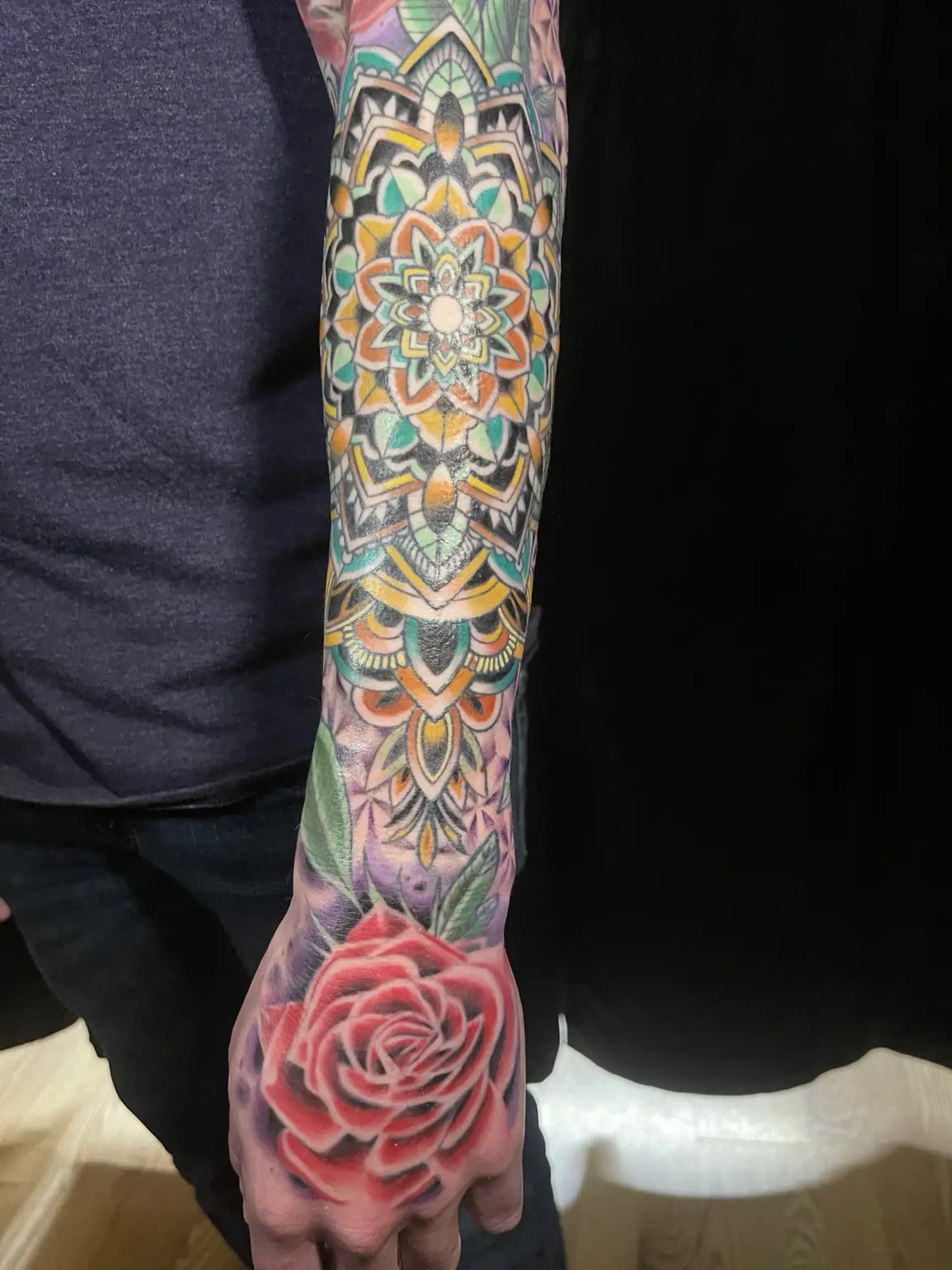 Full-color mandala and rose sleeve tattoo by Keith