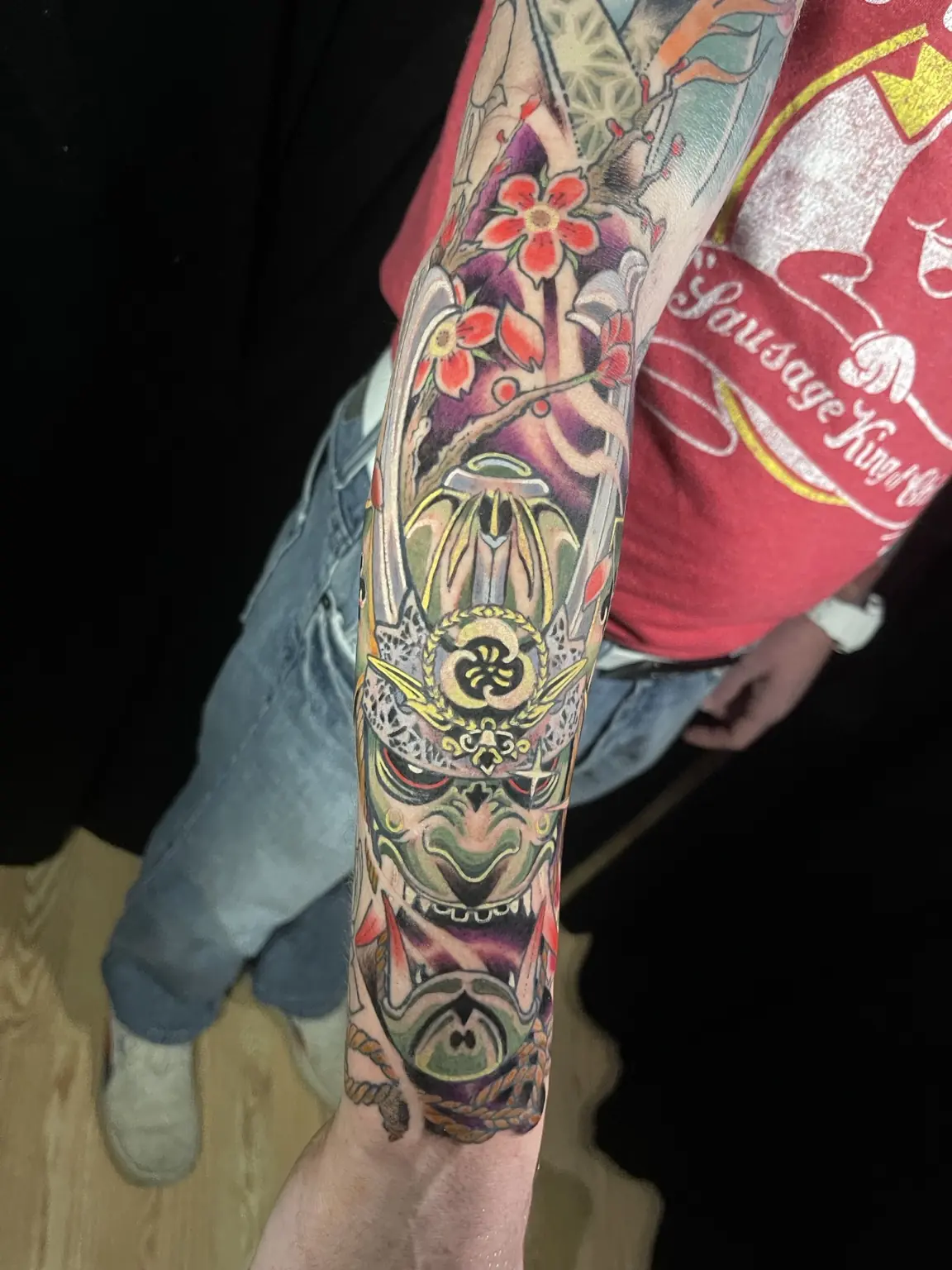 Full-color Japanese-inspired oni mask sleeve tattoo by Keith