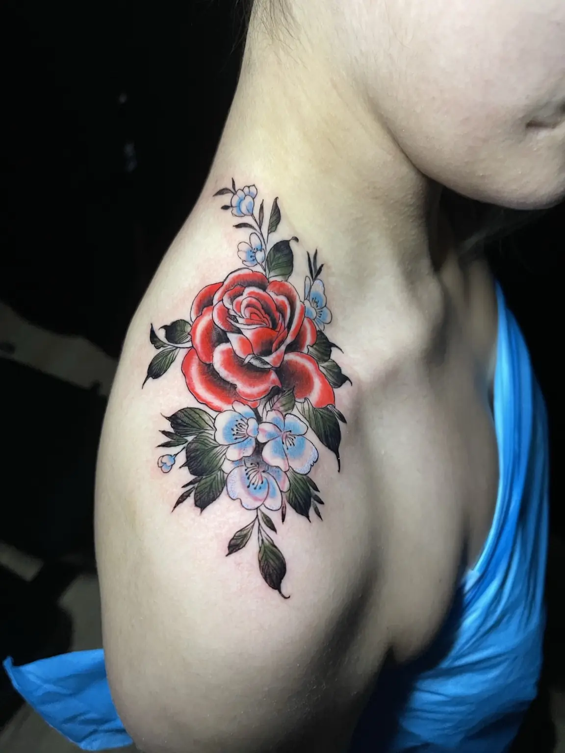 Red rose and floral shoulder tattoo by Keith