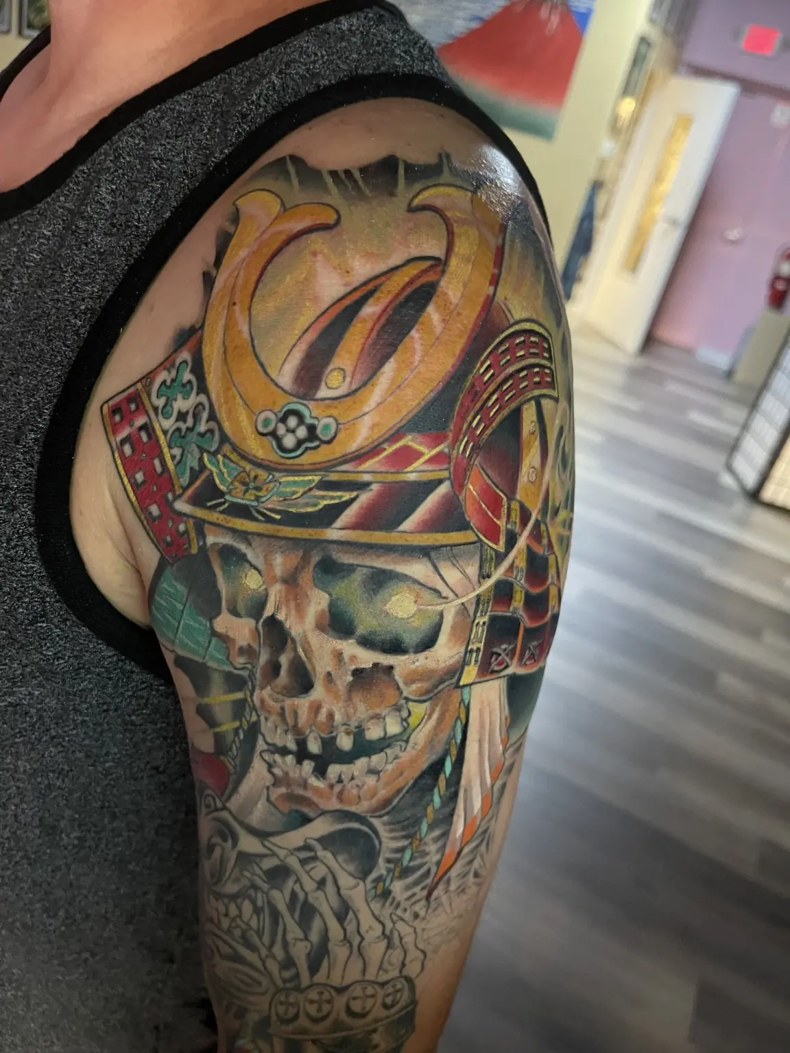 Full-color samurai skull upper-arm tattoo by Keith