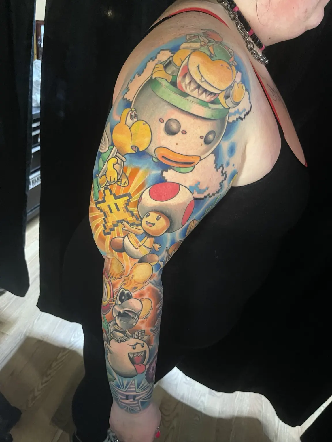 Full-color Super Mario character sleeve tattoo by Keith